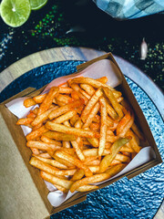French fries being deep-fried in hot oil, crispy and golden snack.
