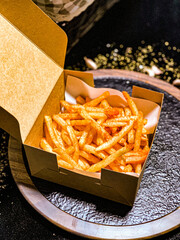French fries being deep-fried in hot oil, crispy and golden snack.