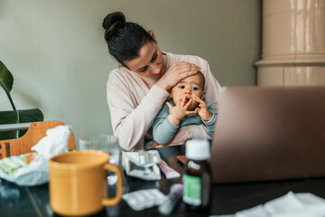 Mother taking care of sick son at home