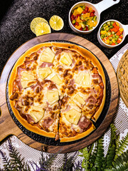 Hawaiian pizza topped with pineapple, bacon, and melted cheese, delicious and savory.