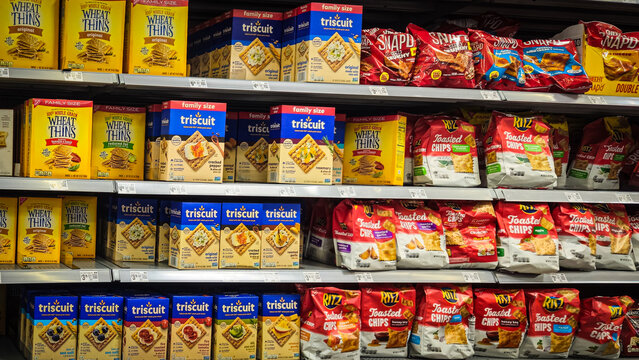 A store shelf stocked with various flavors of Wheat Thins, Triscuits, Ritz, and Cheez It crackers (August 29, 2025). For Editorial Use Only.