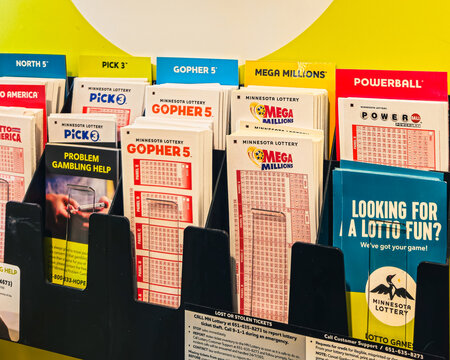 Various lottery play slips and information for games like Powerball and Gophers 5, available at a retail location in Minnesota, USA (August 2025)