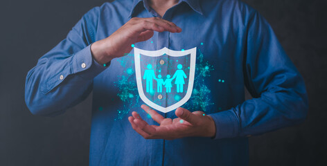 Businessman protecting family life through health insurance policies with shield icons safe...