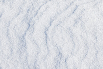Obraz premium Delicate close-up of white snow texture with faint shadows, top view
