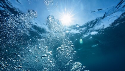 Fototapeta premium bubbles flowing under water with sun shining above; free space for text