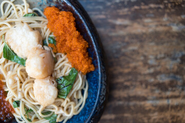 A delightful seafood spaghetti dish featuring shrimp eggs and scallops. Top view