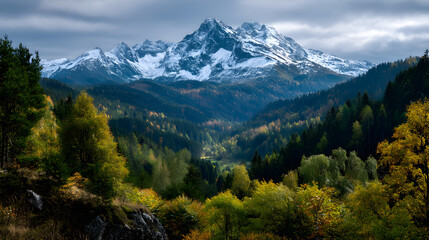 Autumn landscape with golden trees and distant mountin peaks under a clear, brght sky.