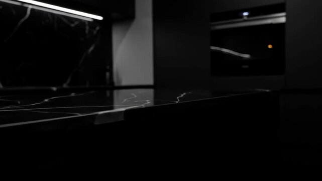 Close-up of black marble countertop with white veins in a modern kitchen interior, showcasing the countertop, modern design, and luxury.
