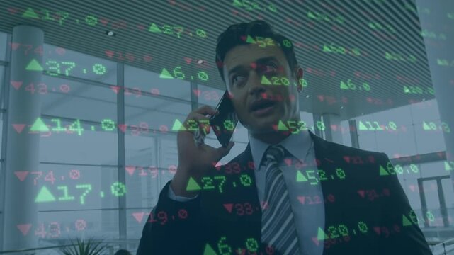 Stock market data processing against caucasian businessman talking on smartphone at office