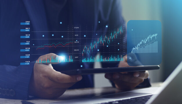 Businessman using tablet to analyze stock market data and financial charts. Modern financial technology, investment strategies and digital economy. Business, finance and wealth management. - Powered by Adobe