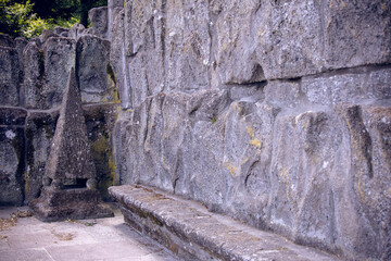Fototapeta premium Old stone wall with bench and pointed architectural detail in Hercules monument