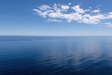 Obraz premium Serene Ocean View with Blue Sky and Clouds Aerial Shot of Calm Water Surface Horizon Seascape