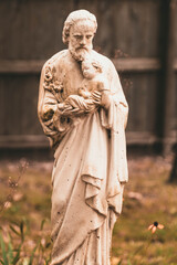 Obraz premium Saint Joseph Holding Baby Jesus Statue in Yard