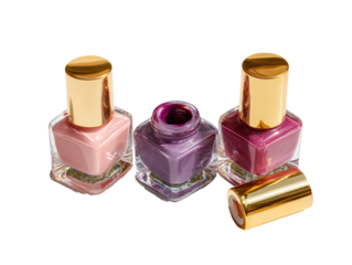 Three nail polish bottles, various shades of pink and purple, gold caps