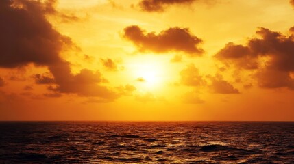 Naklejka premium Serene seascape during sunset with warm hues, golden glow over calm sea, scattered clouds, peaceful natural beauty,