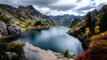 Bright autumn colors surrounding deep alpine lakes i the heart of the mountain.