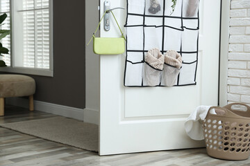 Organizer with different stuff on door and basket indoors