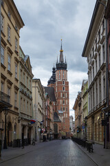 Fototapeta premium View of St. Mary's Basilica from a cobblestone street in Krakow.