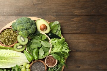 Superfood. Different healthy products on wooden table, top view. Space for text