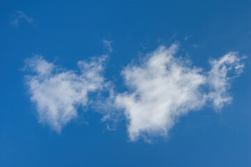 white fluffy textured clouds in clear blue spring sky. photo of natural cloudscape for serene background