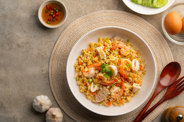 Fried rice seafood,Thai fried rice with pork shrimp and squid in a plate.street food.Top view.