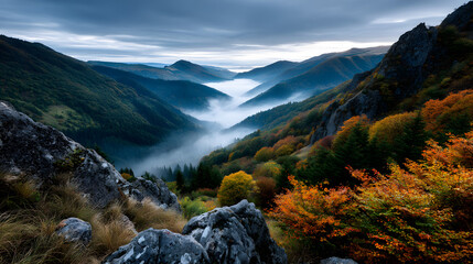 Colorful autumn mountains overlooking a fog-covered alley in early morning.