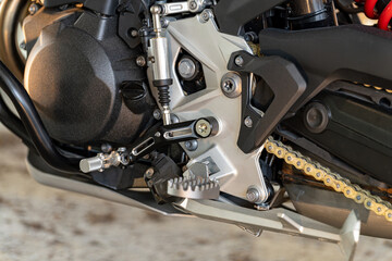 Close-up view of a motorcycle's gear shift and components highlighting precision engineering and design