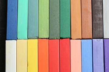 Colorful chalk pastels as background, top view