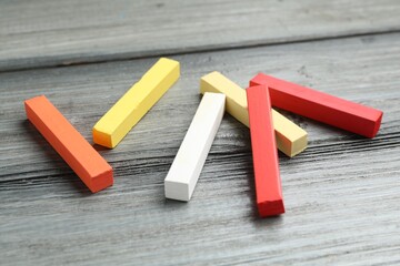Colorful chalk pastels on wooden table, closeup