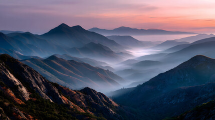 Fototapeta premium Colorful mountain range fading into a foggy valley a golden hour.