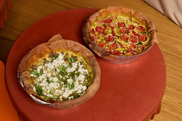 Delicious Quiches Arranged Beautifully on a Table Surrounded by Fresh Ingredients Galore