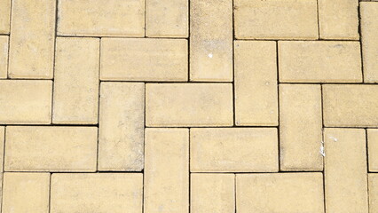 Top view of a yellow brick stone for a sidewalk and driveway. Pavement tiles texture and background