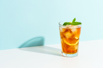 Summer cold drink on colored background with hard shadows.