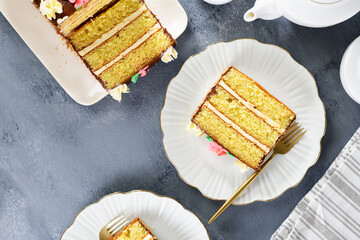 Sliced ​​layered cake with buttercream on white plate, top view
