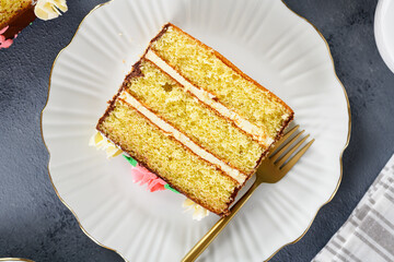 Sliced ​​layered cake with buttercream on white plate, top view