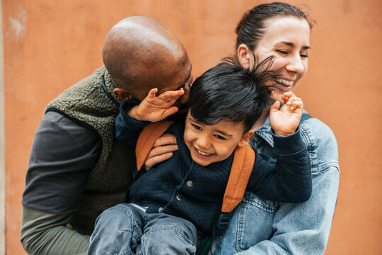Mother and father enjoying leisure time playing with son