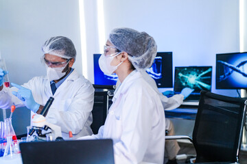 A team of scientists in a high-tech lab collaborates on genetic and medical research. They use microscopes and test tubes to analyze samples for a new discovery.