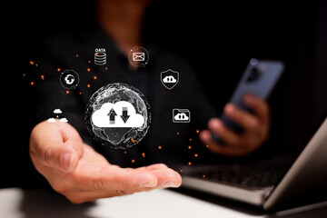 A hand extends towards a digital globe, surrounded by cloud icons and data symbols, symbolizing cloud technology and data management.