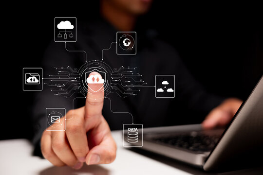Cybersecurity data control concept. A business person touches a virtual cloud upload button on a futuristic interface surrounded 