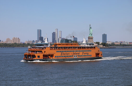 New York, NY, USA - August 22, 2025: yellow ferry sailing from manhattan to staten island for free for tourists and commuters who can see the famous statue of liberty