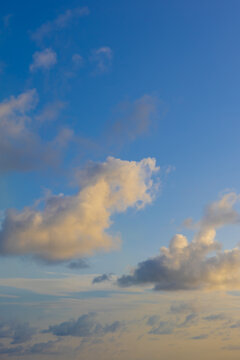 Vertical images of beautiful impressive cloudscape light blue and gold different cloud types 