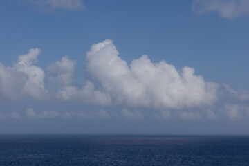 Ocean horizon images beautiful calm water surface on pertly cloudy day on the Western Caribbean Sea