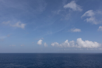 View from balcony of a Western Caribbean cruise looking out to endless ocean and beautiful cloudscape