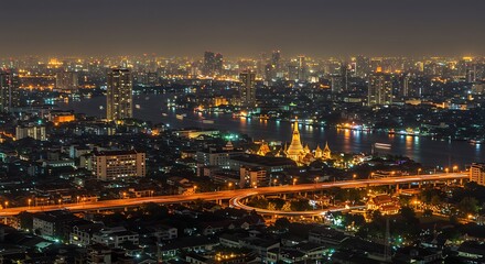 Obraz premium Bangkok Cityscape at Night with Illuminated Buildings and Roads.