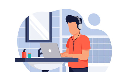 Man working remotely on his laptop with headphones in a bathroom setting, highlighting flexible work environments and remote productivity.