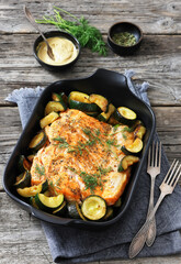 freshly baked salmon fillet with zucchini and dill