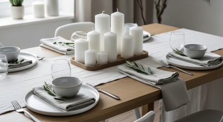 Elegant Dining Table Setting with Pillar Candles and Rosemary Accents