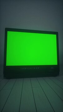 Retro CRT Television With Green Static Screen in Dark Minimalist Room