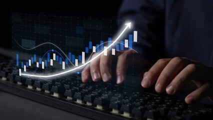 Close-up of hands typing on a keyboard with an overlay of financial graphs, illustrating the data analysis and market trends in a modern workspace. Copula