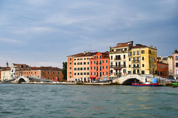 Old white stone bridges and colorful buildings in Venice, Italy